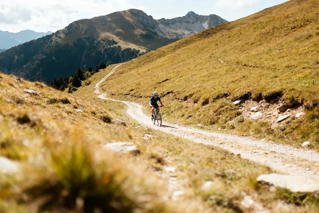 Vélo sur chemin de montagne, illustrant la définition du dénivelé en randonnée.